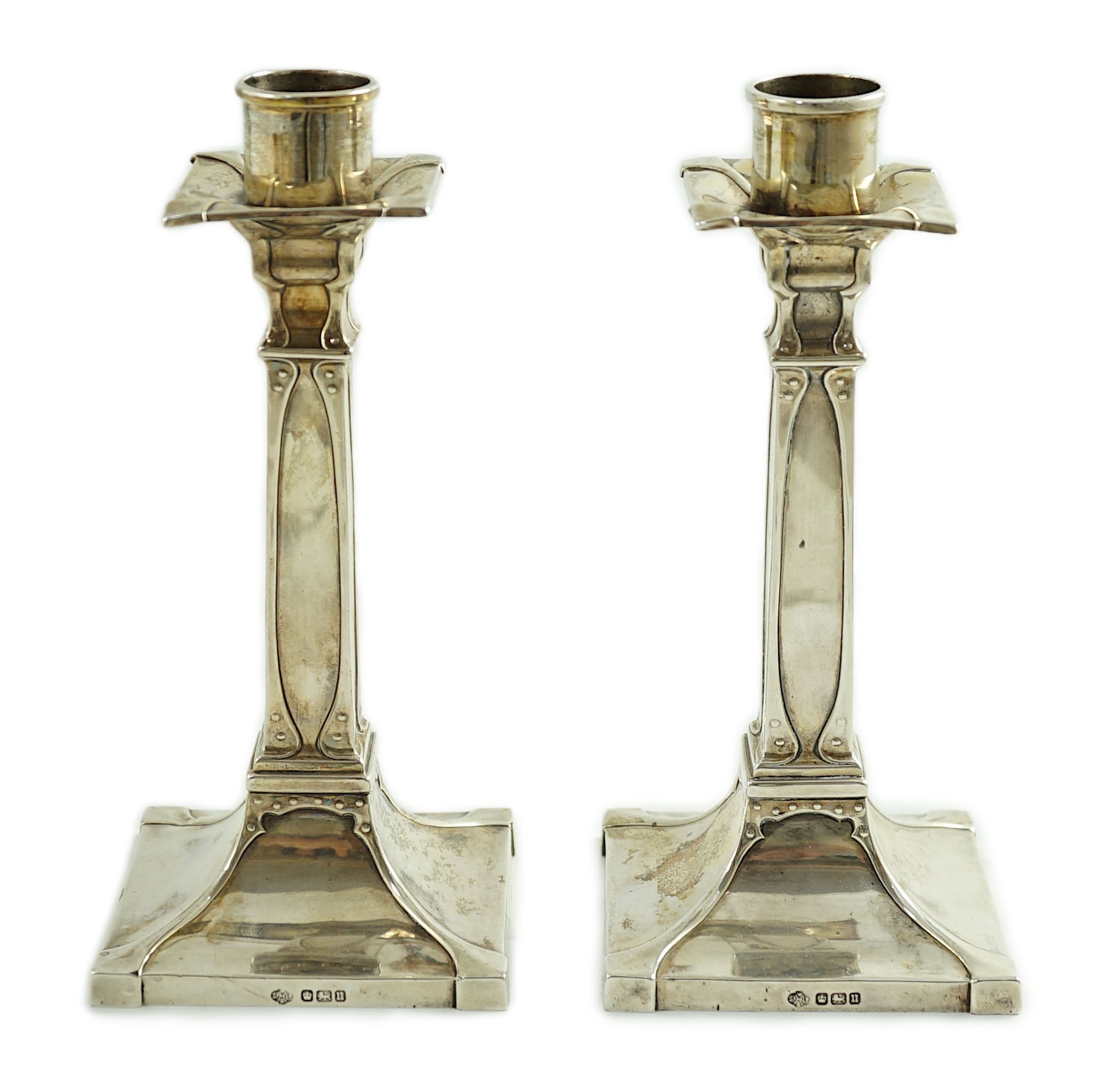 A pair of George V Arts & Crafts silver candlesticks, by William Hutton & Sons